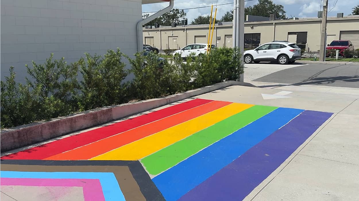 Large Progress Pride flag painted over pavement