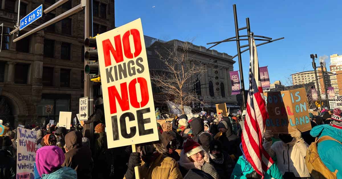 A group of protesters, one sign says "No Kings No Ice"
