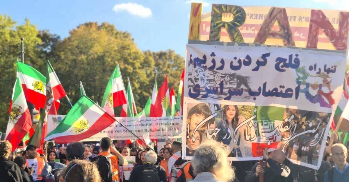A group of people holding flags of Iran and protest signs