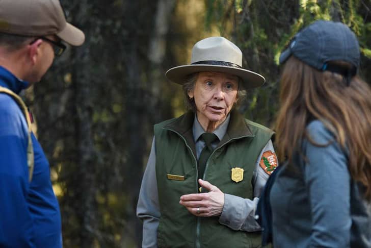 A park ranger talking to two visitors