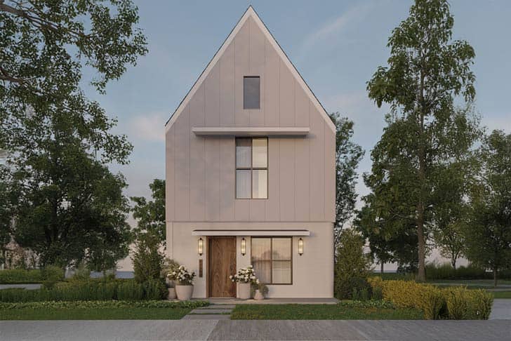A two-story house in white and grey tones with trees around it