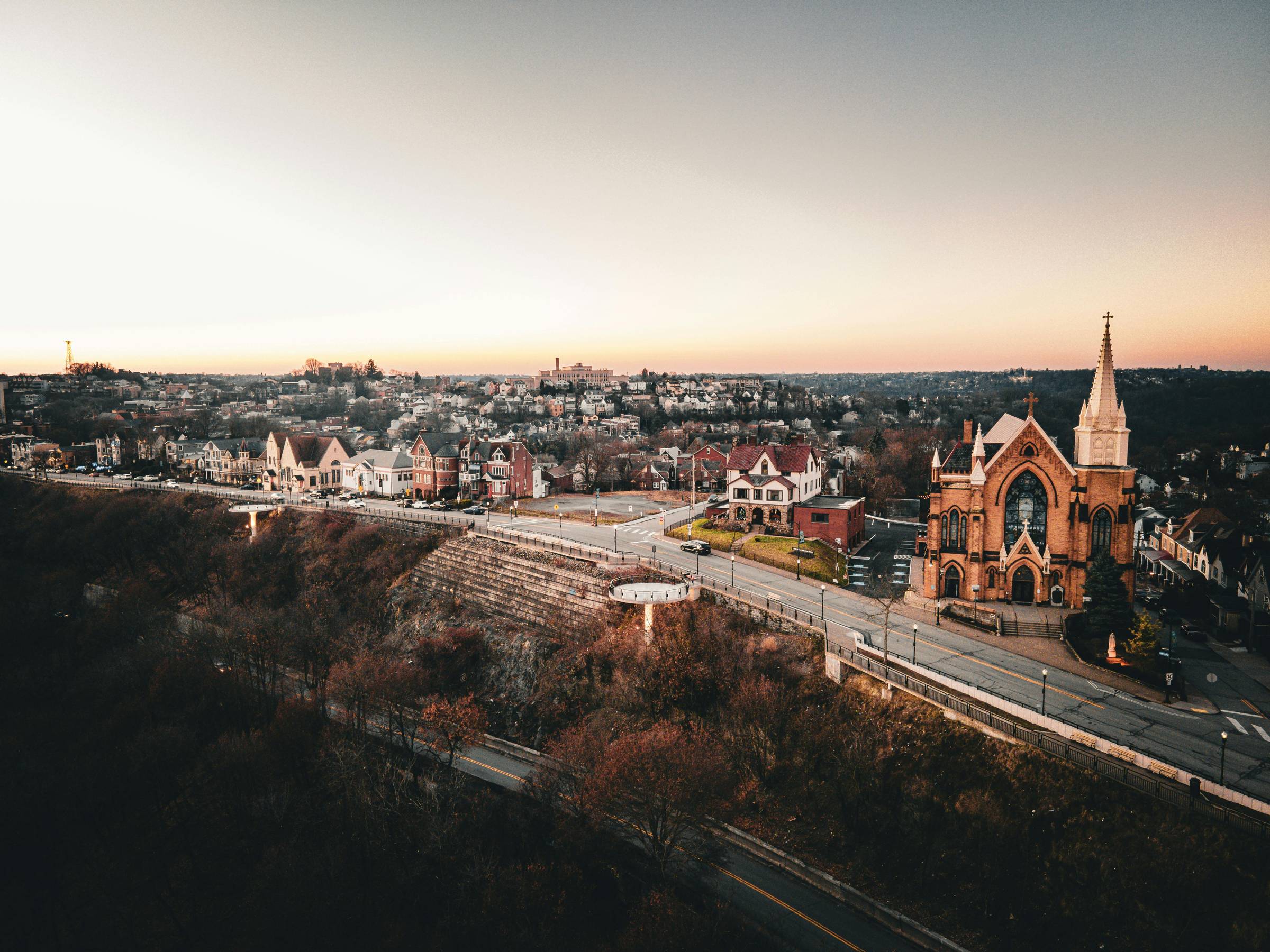 Wide photo of a church in a neighborhood