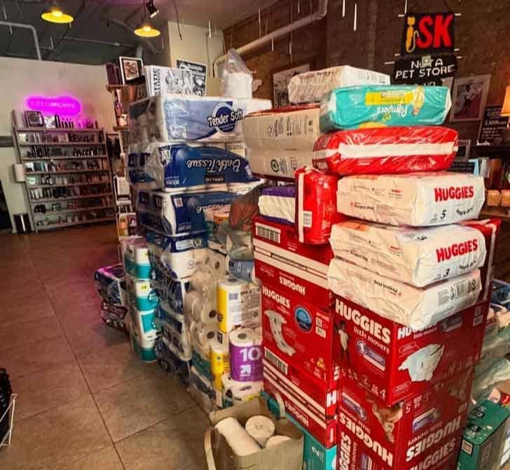 Diapers, paper towels, and other items stacked in the middle of a sex shop