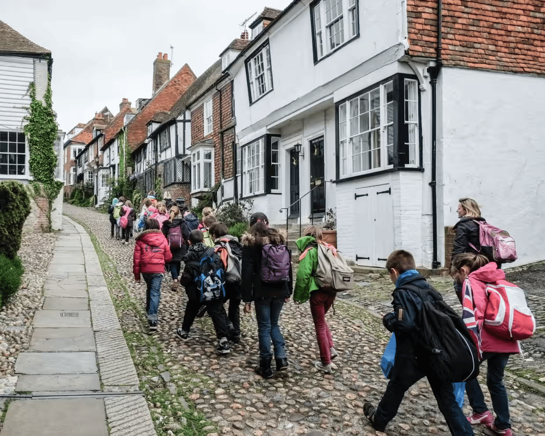 Group of kids walking on a stone street