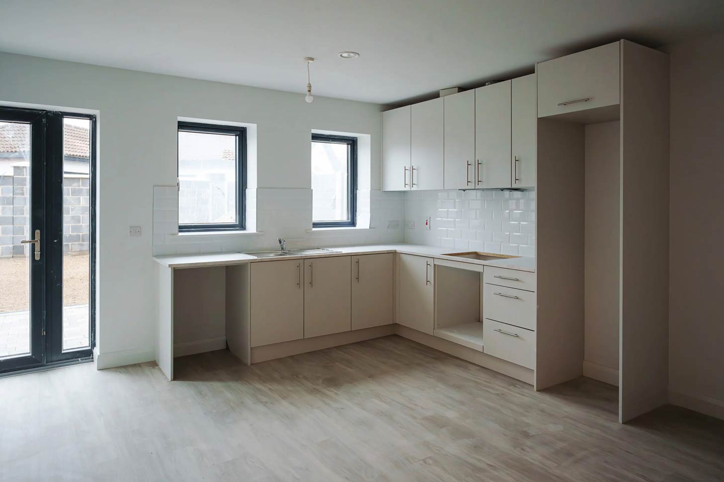 Inside of an unfurnished home, specifically the kitchen