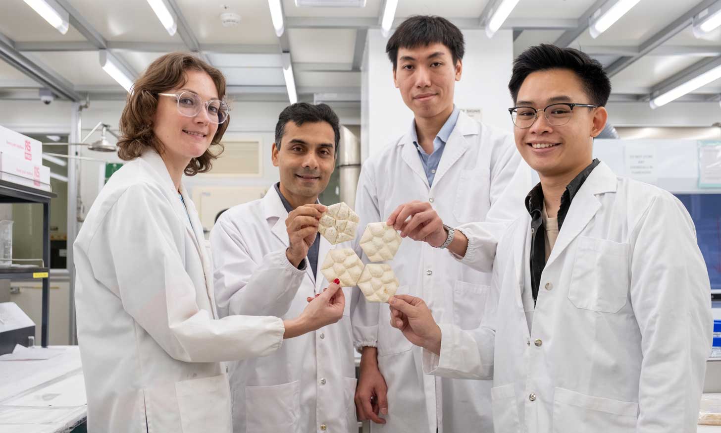 Four scientists holding their tile innovation