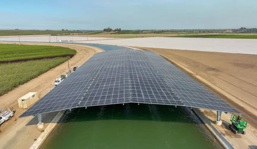 A solar power "shield" over a canal waterway with fields on either side