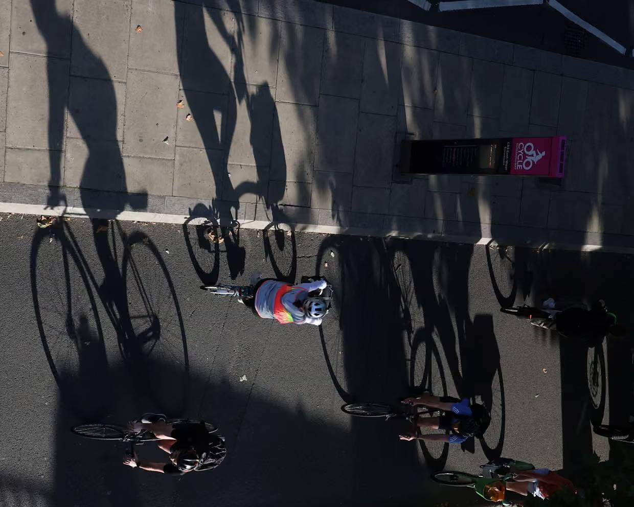 Bird's eye view of bicycles on a roadway next to a sidewalk