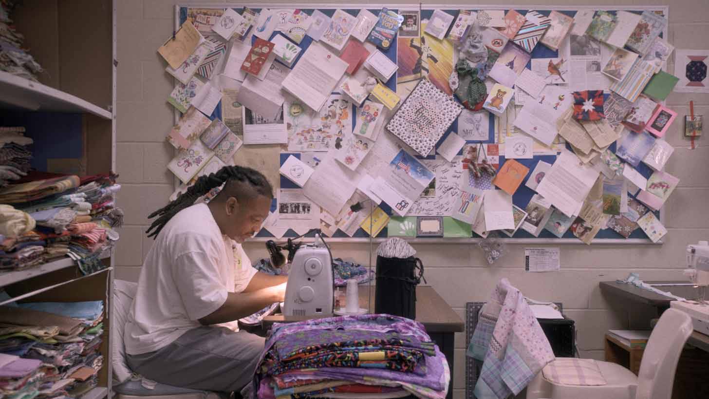 Person sitting at sewing table