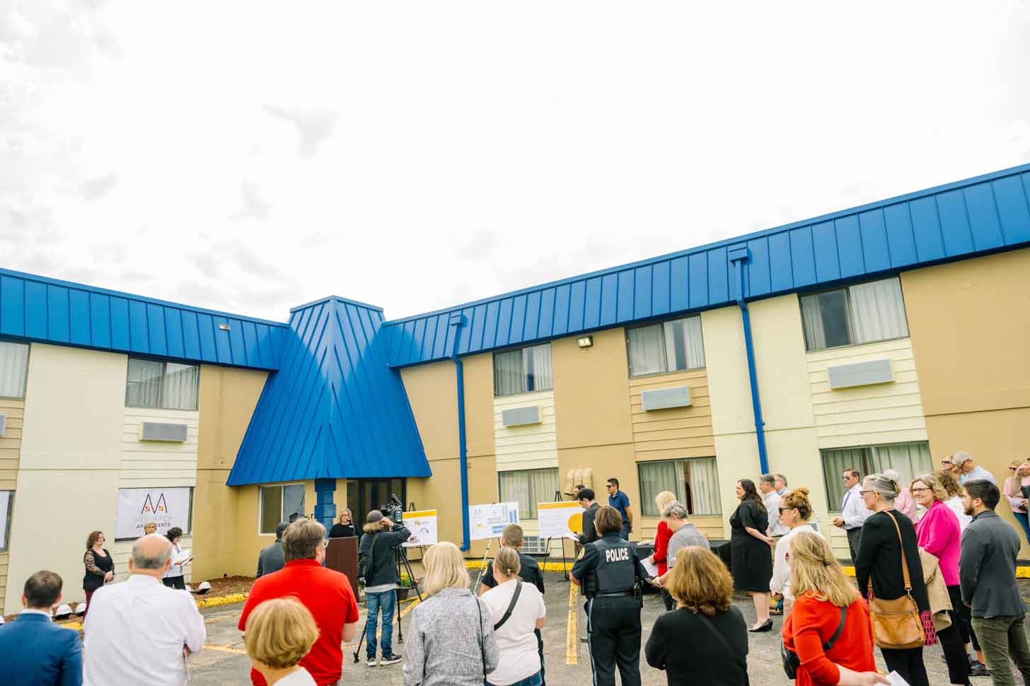 People standing outside a hotel building