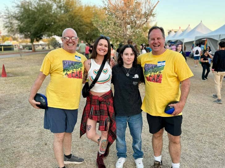 Two dads with two Pride attendees