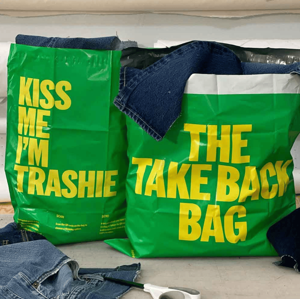 Two large green shipping bags with "take back bag" in yellow text