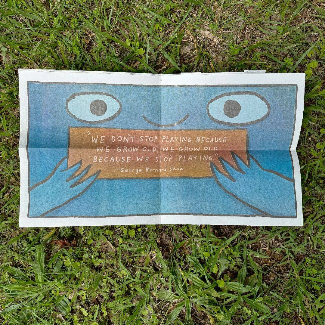 Centerfold poster of a newspaper with a quote that reads "We don't stop playing because we grow old; We grow old because we stop playing." — George Bernard Shaw