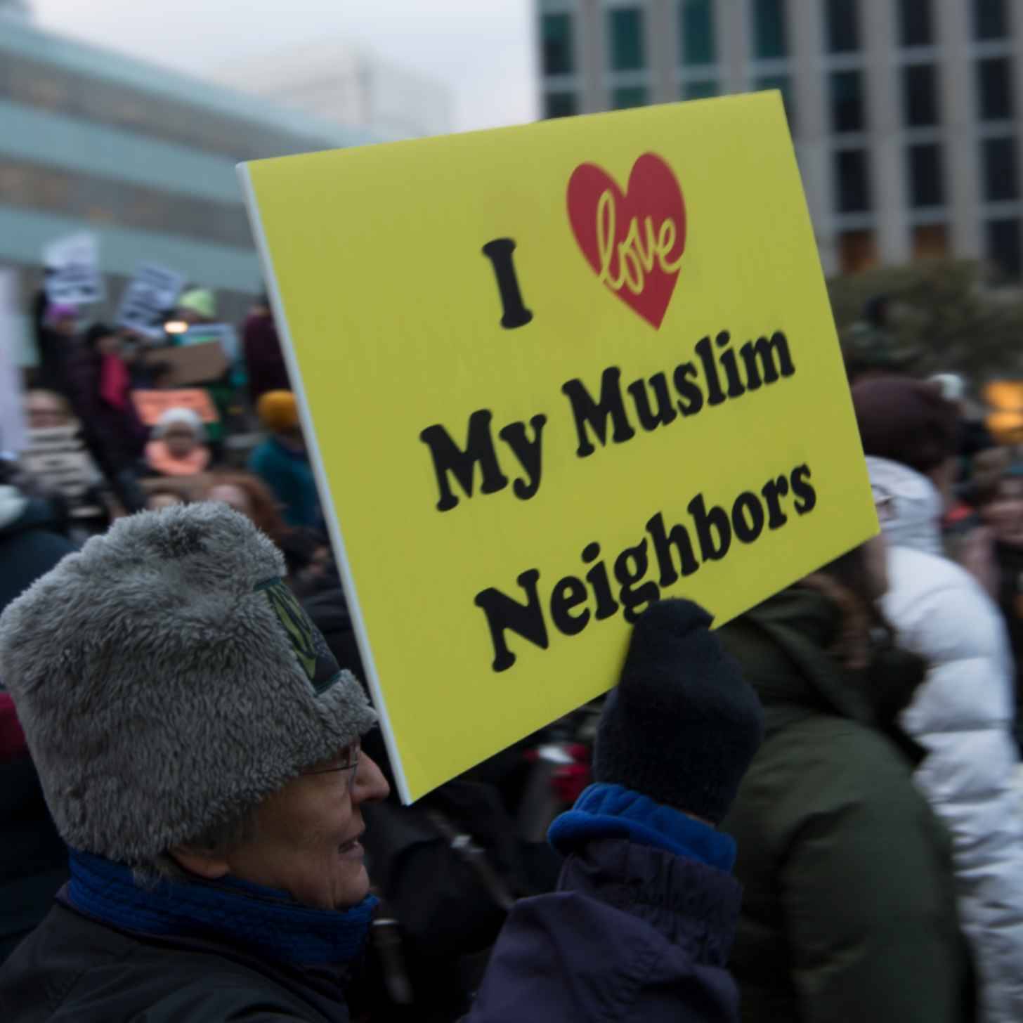 Person holding a sign that says "I Love My Muslim Neighbors"