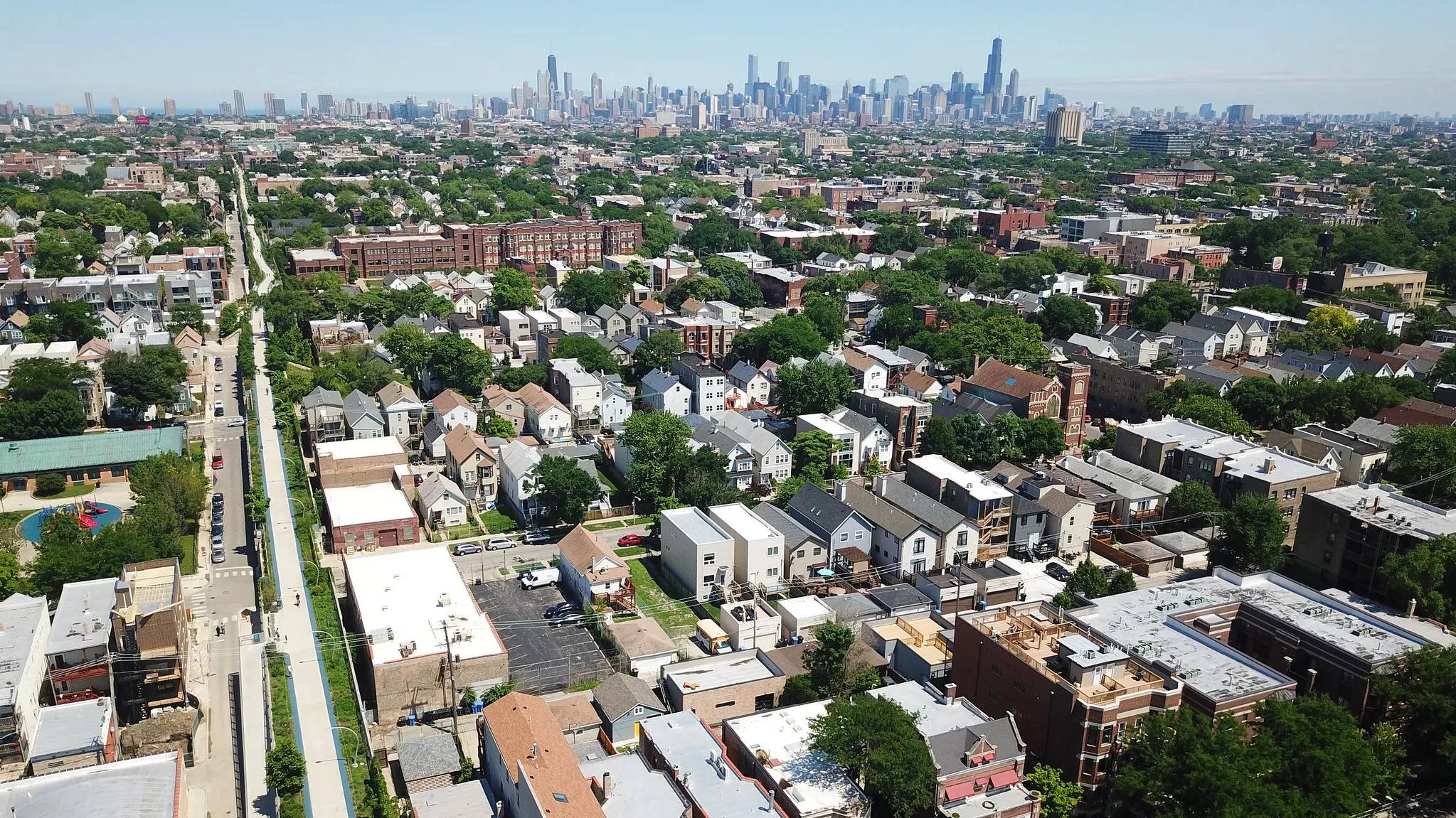 Bird's eye view of a Chicago neighborhood with the skyline in the background
