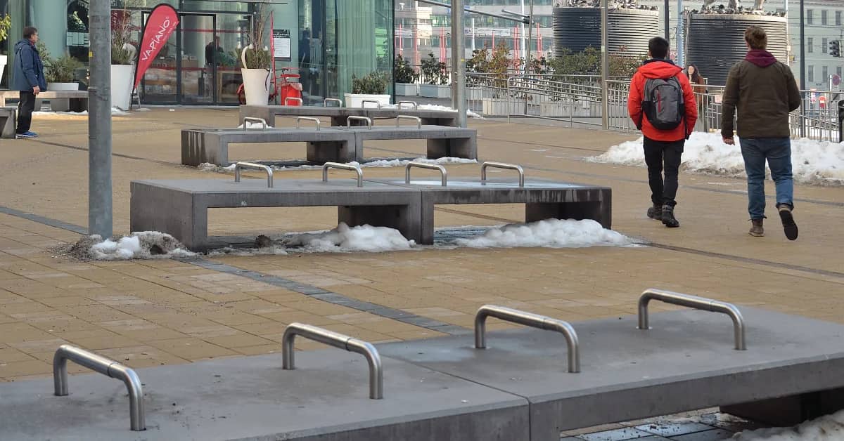 Concrete benches with large metal bars installed in the top