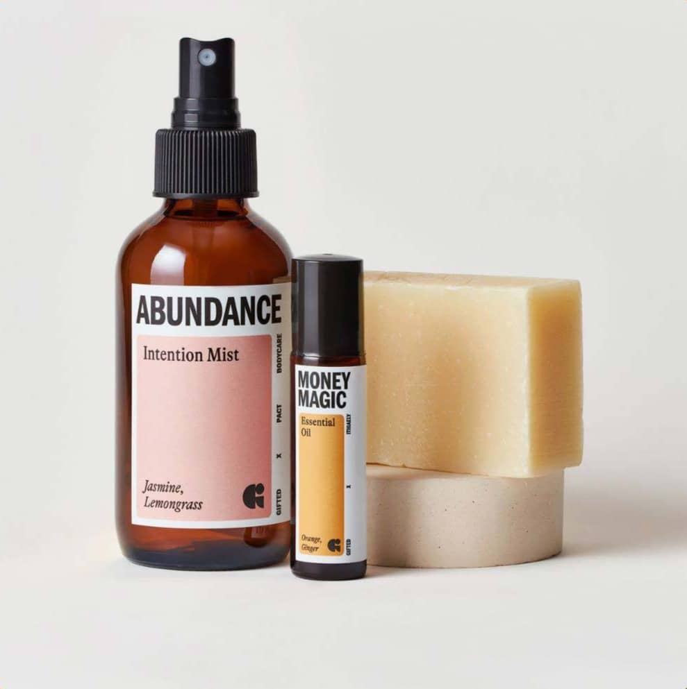 Two amber bottles of product, with two bars of soap behind them