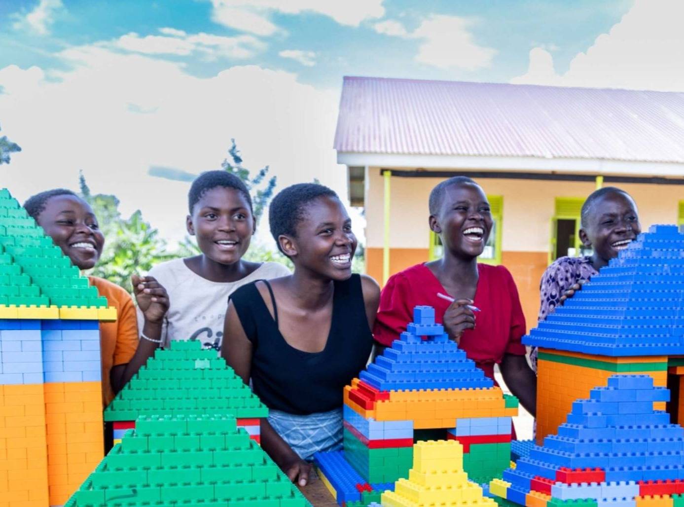 People smiling behind a large lego display