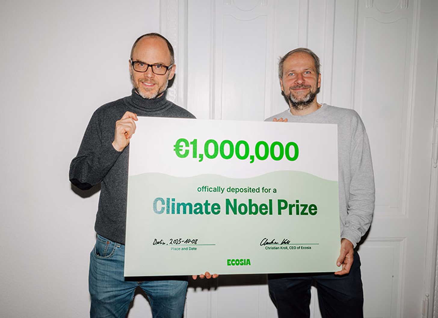 Two people standing with a big sign that says 1 million euros officially deposited for a Climate Nobel Prize