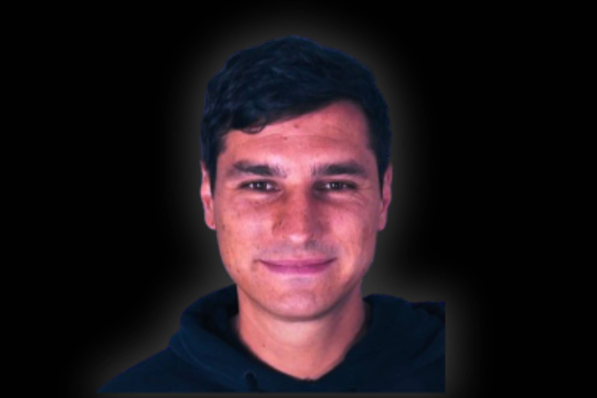 a man standing in front of a tree