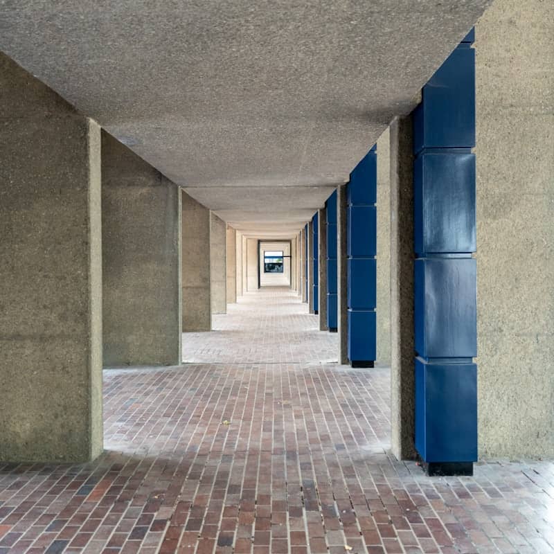 Concrete walkway with blue accents and brick floor