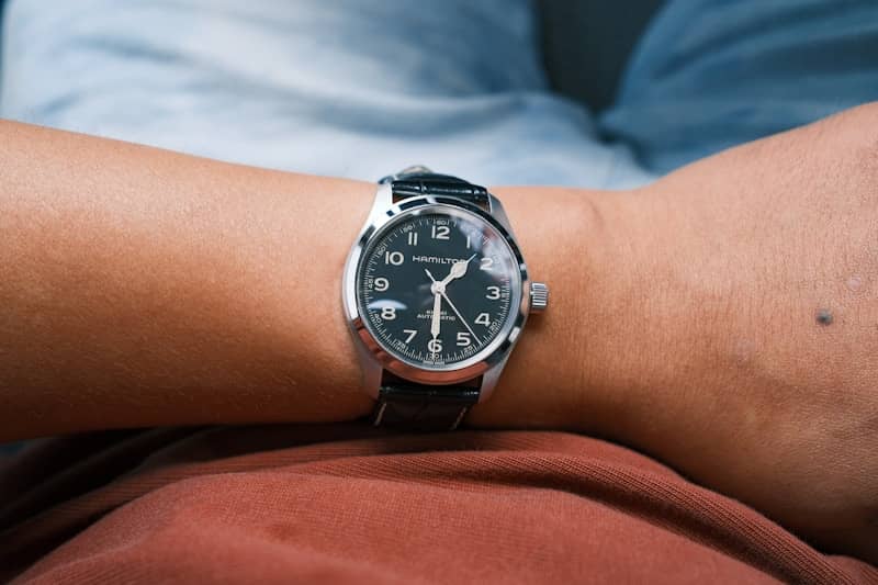 Man wearing a wristwatch on his arm.