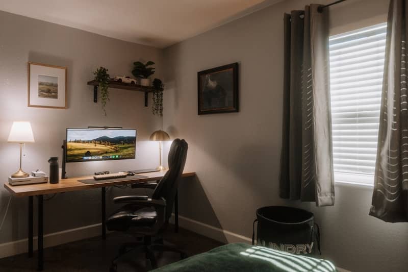 Cozy home office with desk and computer.
