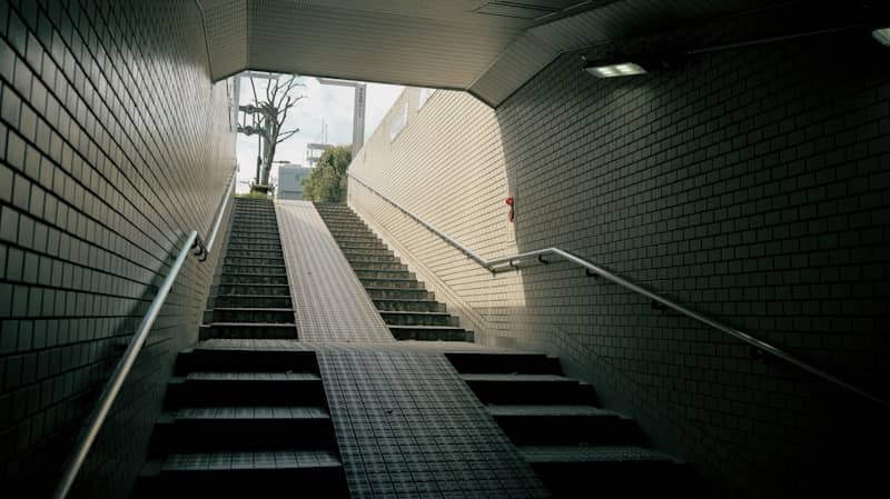 Stairs leading up and out of a dark underpass