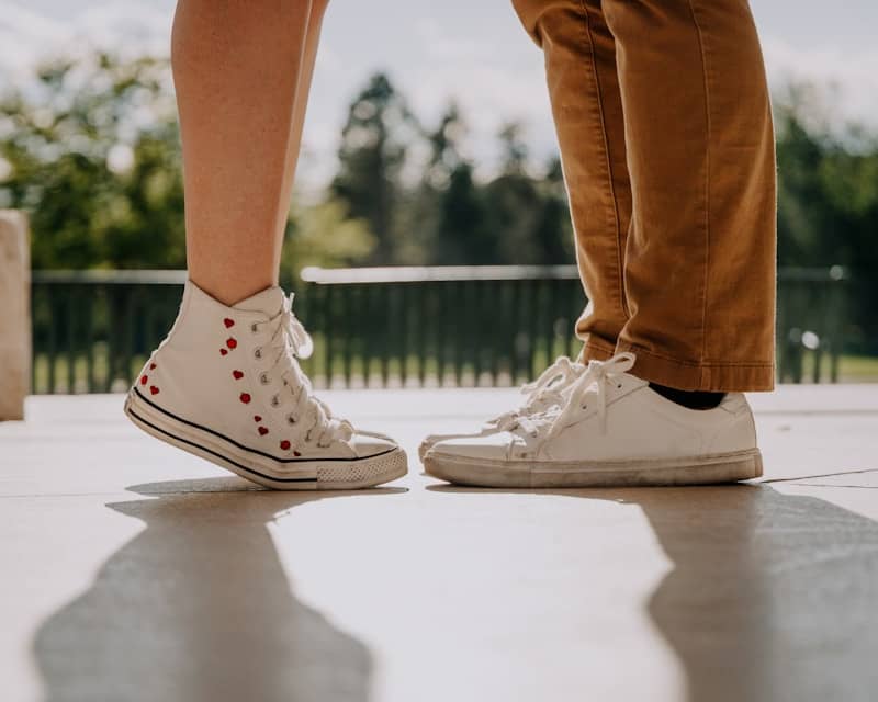 Couple's feet standing close together outdoors