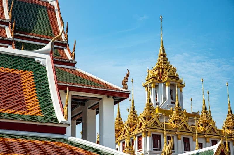Ornate golden temple spires against a blue sky.
