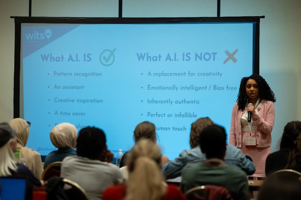 WITS attendees take notes at long conference room tables