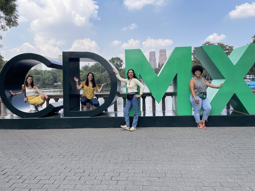 Four Wanderful Members pose in the giant CDMX letters of Mexico City