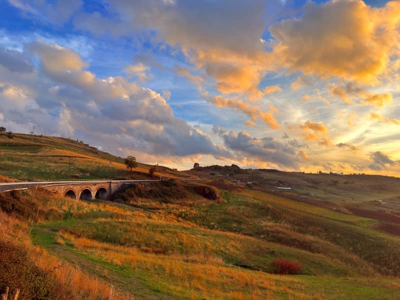 Rolling hills and clouds at sunset