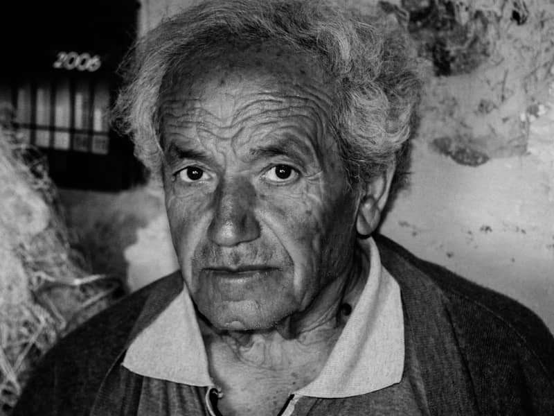 An elderly man with wrinkled face and gray hair