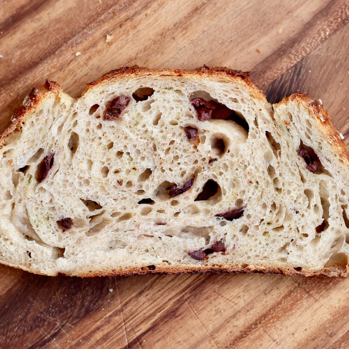 A slice of kalamata olive sourdough bread.