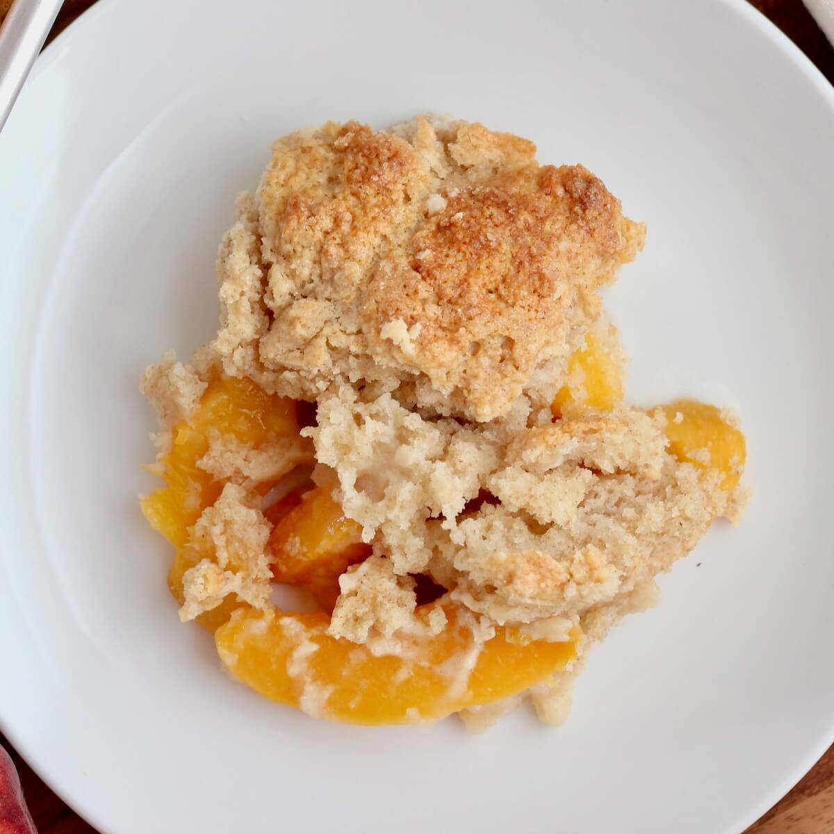 A plate of sourdough peach cobbler.
