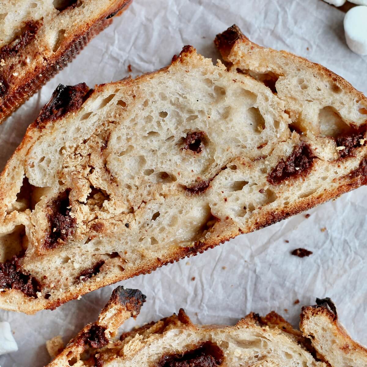 A slice of s'mores sourdough bread on parchment paper.