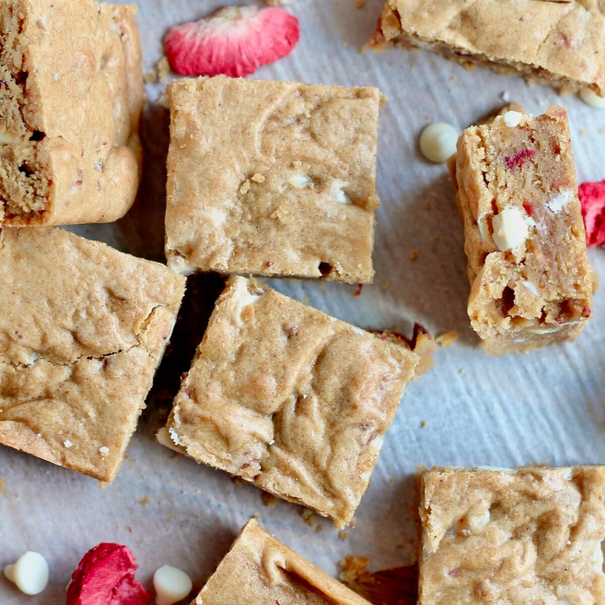 Strawberry Sourdough Blondies on a sheet of parchment paper.