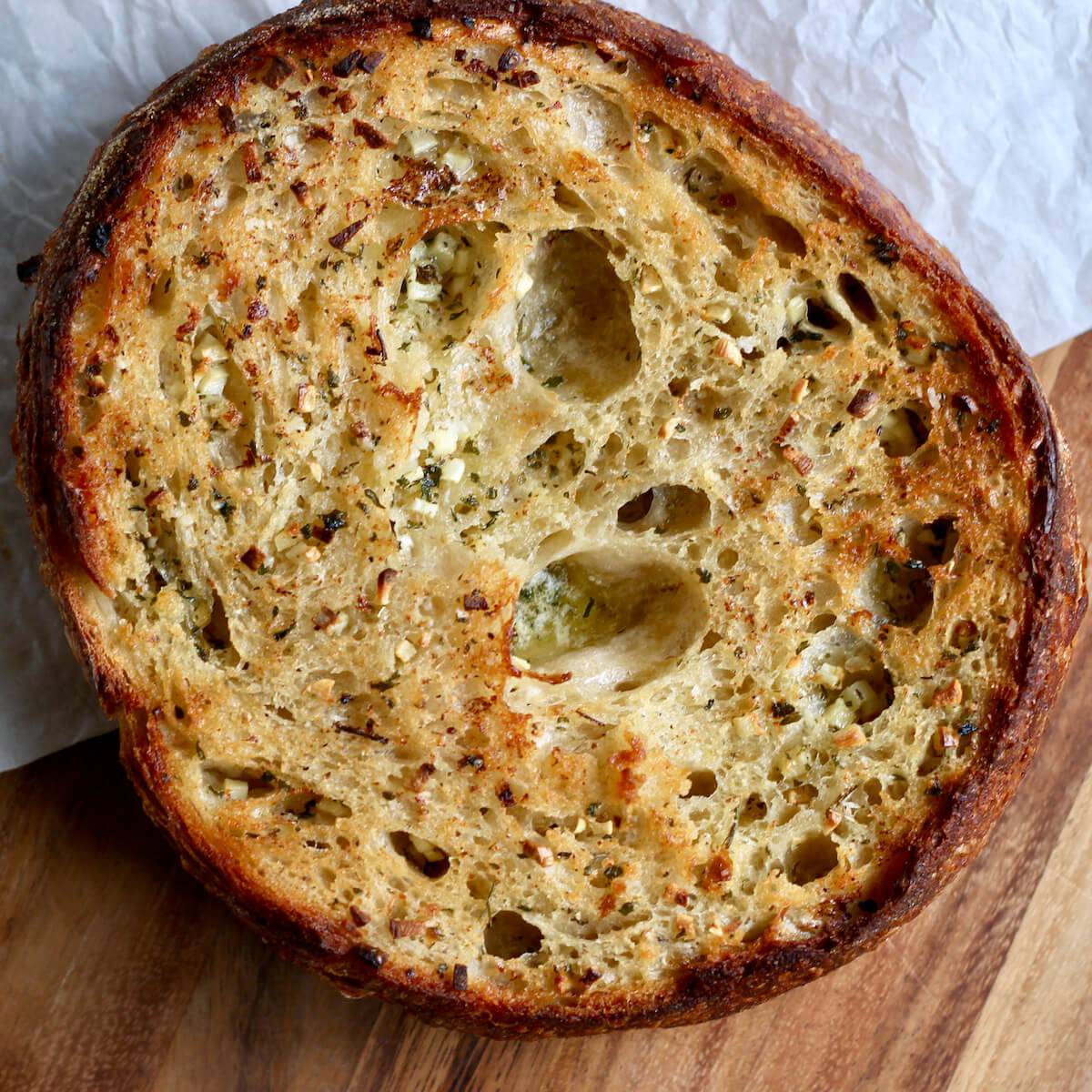 Sourdough garlic bread on a cutting board.