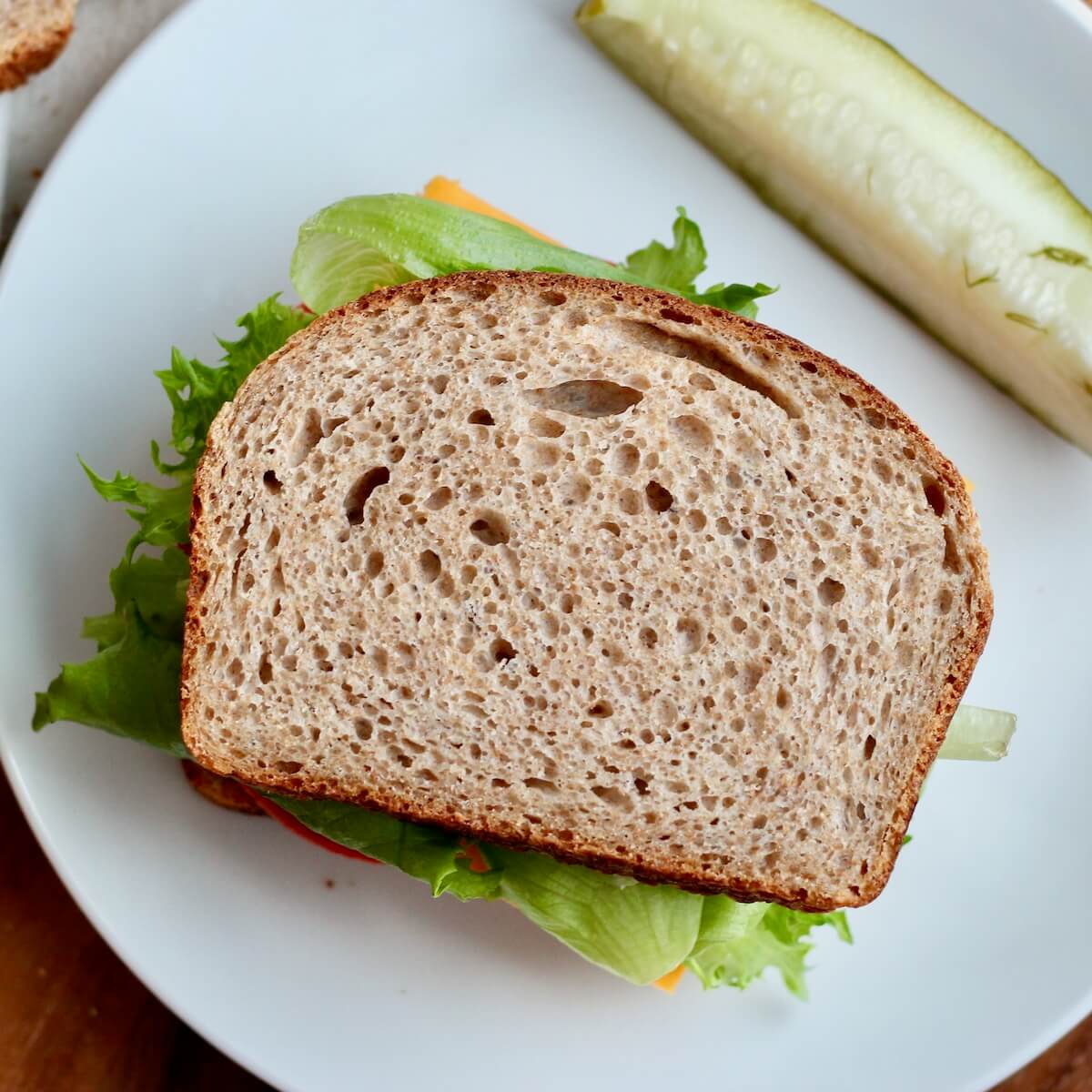 A sandwich made on whole wheat sourdough sandwich bread.