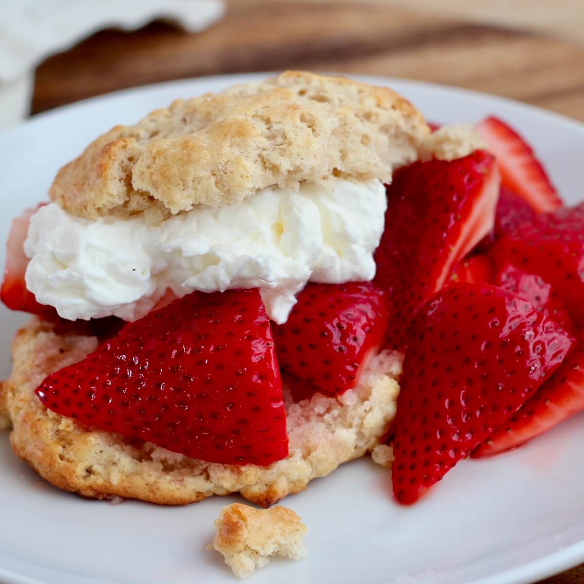 Sourdough strawberry shortcake on a small white plate.