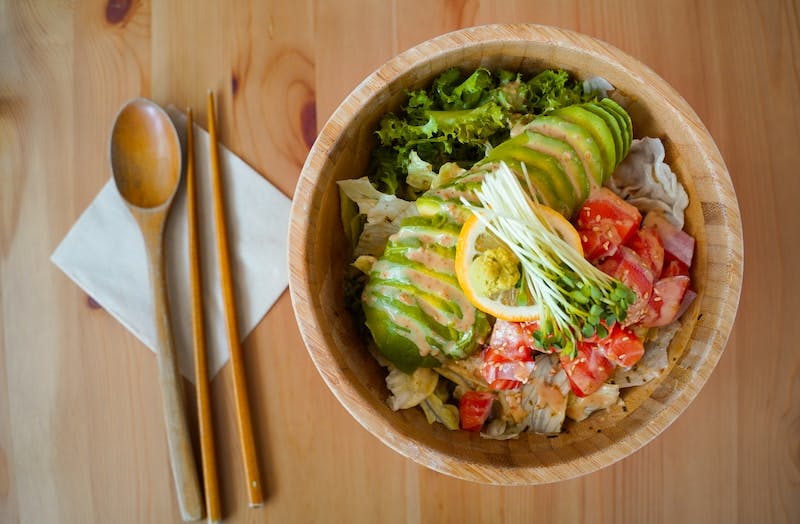 vegetable salad on brown wooden bowl