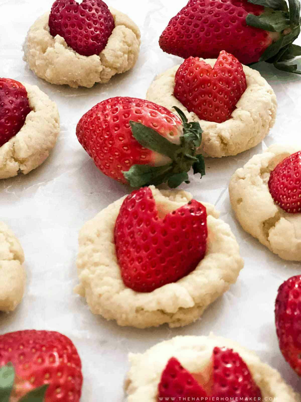 cookies with strawberries on top shaped like hearts