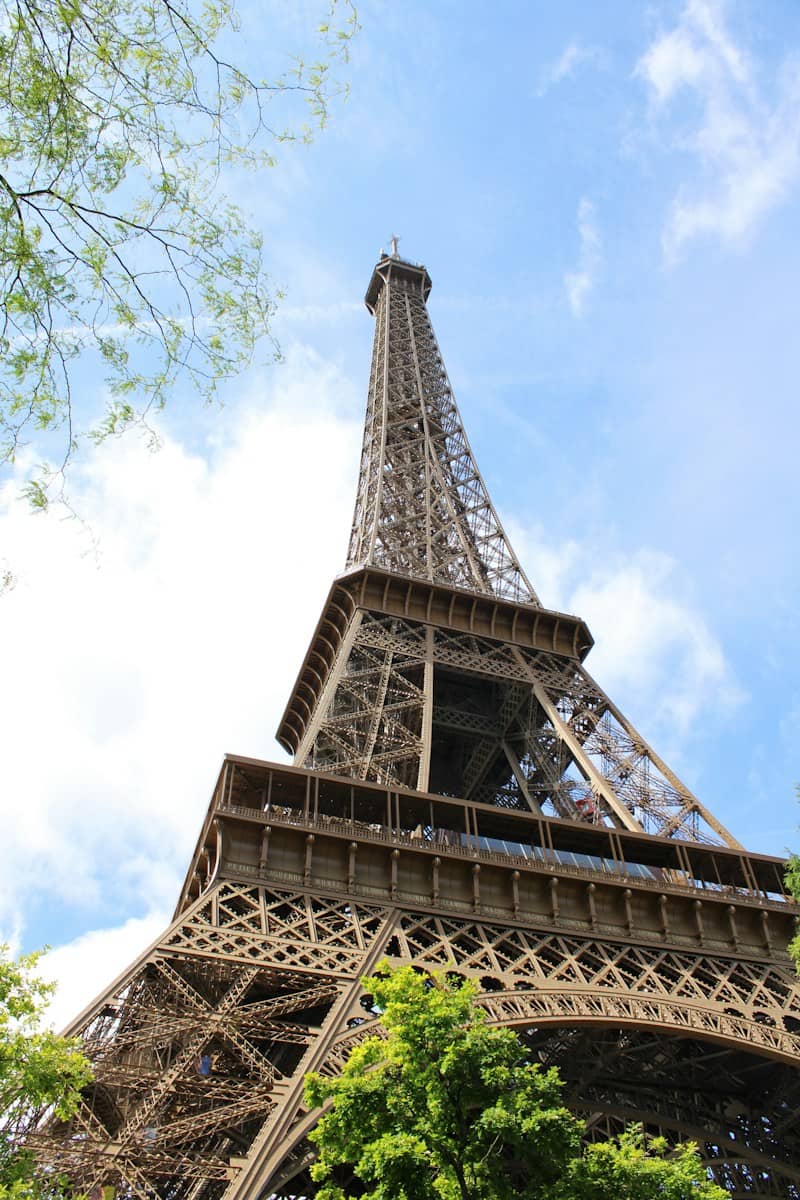The eiffel tower soars against a bright blue sky.