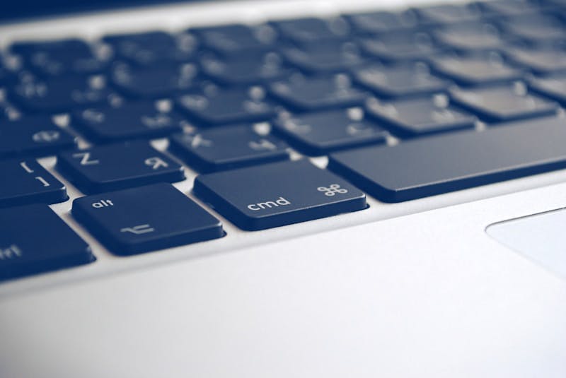 A close up of a computer keyboard with a blue background