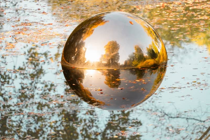 Large reflective sphere floating on water surface