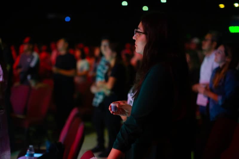 A woman standing in front of a crowd of people