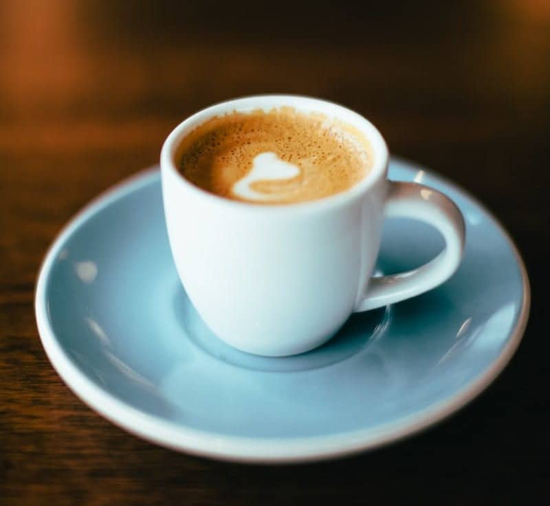 selective focus photography of latte in teacup