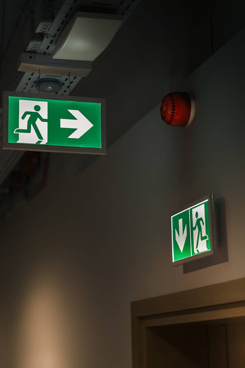 A green and white sign hanging from the ceiling