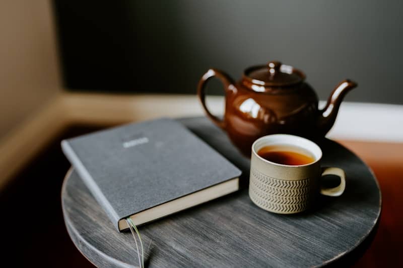 A cup of tea and a book on a table